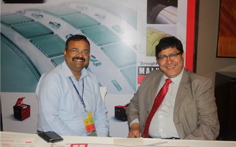 Satish Naik of Bodhi Professional Solutions and Bimal Chaku of Malhotra Graphics discussing the labeling technology