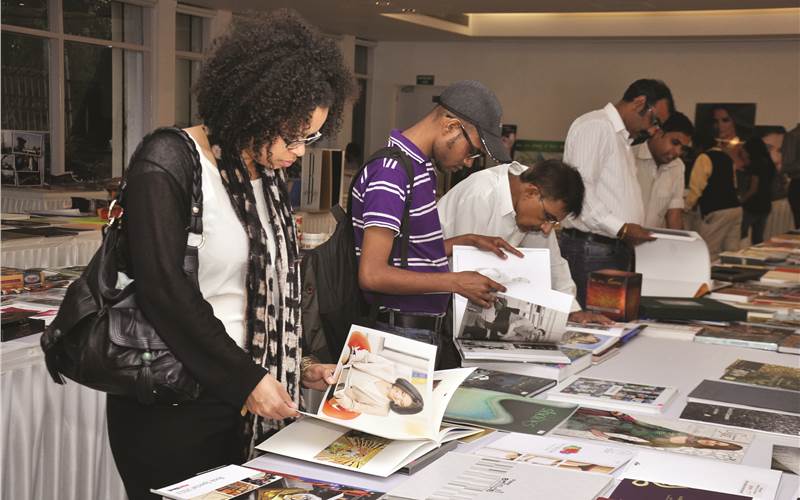 Print buyers looking at the displayed print samples