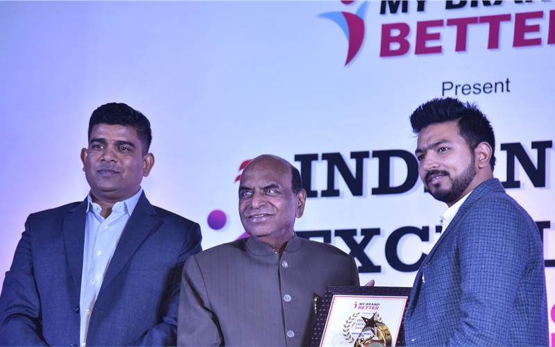 Smarth Bansal (left), senior product manager, Colorjet receives the award from Devi Prasad Tripathi, member of parliament and general secretary of the National Indian Congress