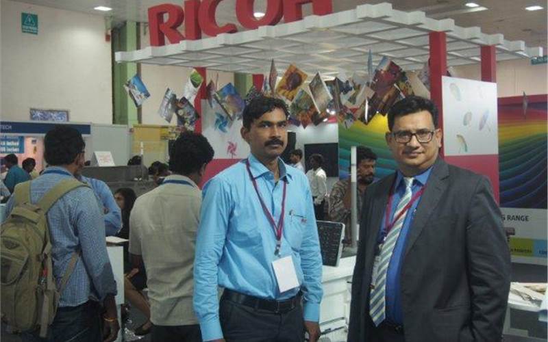 "The southern market has a huge potential for digital colour presses, especially in the Tier two and three cities and towns. In fact our 5100 series would be the right fit for the photo labs in these cities," said Sambit Misra, chief operating officer for production printing, Ricoh India- Standing here with his colleague in front of their stylised stand